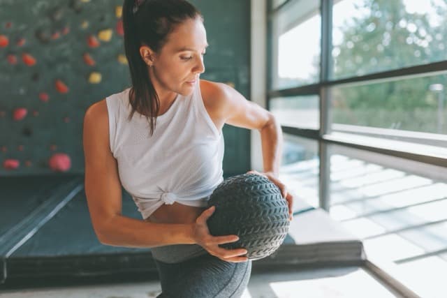 Woman exercising with medicine ball