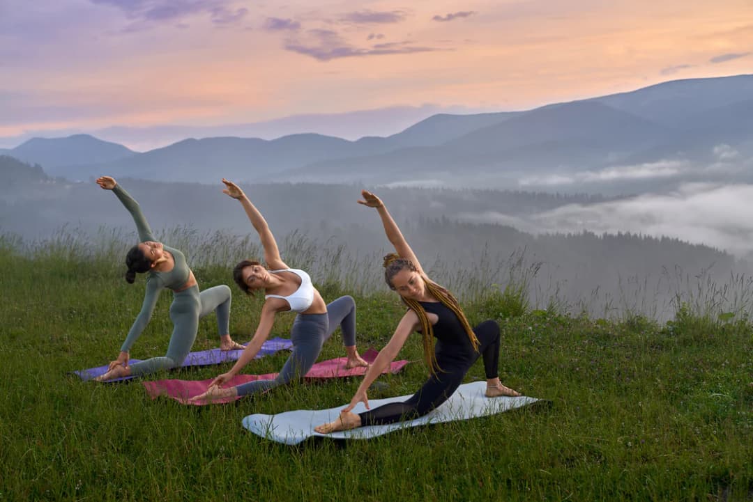 Women practicing yoga in nature